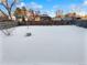 Large backyard covered in snow, with a wooden fence at 481 S Lima Cir, Aurora, CO 80012