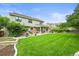 A well maintained lawn featuring a patio, outdoor furniture, and a meticulously landscaped yard at 2974 E Otero Cir, Centennial, CO 80122