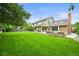 Lush backyard featuring expansive lawn, outdoor seating, and a landscaped patio for entertaining at 2974 E Otero Cir, Centennial, CO 80122