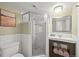 Bathroom featuring a glass shower, white subway tile, and a wooden vanity with modern fixtures at 2974 E Otero Cir, Centennial, CO 80122