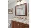 Bathroom vanity featuring a granite countertop, modern faucet, and decorative mirror at 2974 E Otero Cir, Centennial, CO 80122