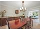 Open dining area with wood table, stylish chandelier, and views into the living area at 2974 E Otero Cir, Centennial, CO 80122