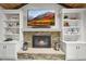Close-up of stone fireplace surrounded by built-in shelves, perfect for display at 2974 E Otero Cir, Centennial, CO 80122