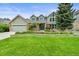 Charming two-story home with well-manicured lawn, mature trees, and beautiful flower beds at 2974 E Otero Cir, Centennial, CO 80122