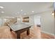 The game room is open and leads to the living room with ping pong table at 2974 E Otero Cir, Centennial, CO 80122