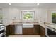 Bright kitchen features granite countertops, stainless steel appliances, and a farmhouse sink at 2974 E Otero Cir, Centennial, CO 80122