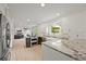 Modern kitchen featuring granite counters, stainless steel appliances, and white cabinetry at 2974 E Otero Cir, Centennial, CO 80122