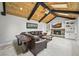 Cozy living room features a fireplace, built-in shelving, vaulted ceilings, and a leather couch at 2974 E Otero Cir, Centennial, CO 80122