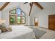 Bright main bedroom featuring vaulted ceilings, exposed beams, and large windows at 2974 E Otero Cir, Centennial, CO 80122