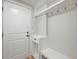 Clean mudroom features a built in bench, shelving and coat hooks by the entry door at 2974 E Otero Cir, Centennial, CO 80122