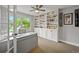 Bright office space featuring built-in shelving, a ceiling fan, and a large window at 2974 E Otero Cir, Centennial, CO 80122
