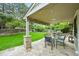 Covered patio with stone flooring, dining set, and outdoor grill in a private backyard at 2974 E Otero Cir, Centennial, CO 80122