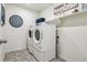 Functional laundry room showcasing modern, full-size, appliances and storage shelving at 3218 Belleville Ridge Rd, Elizabeth, CO 80107