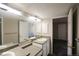 Bright bathroom featuring a double vanity, large mirror, and neutral color scheme at 1652 Egret Way, Superior, CO 80027