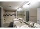 Well-lit bathroom with double sinks, a large mirror, and a shower-tub combination at 1652 Egret Way, Superior, CO 80027