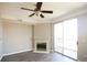 Living room featuring a fireplace, ceiling fan, and sliding glass doors to a balcony at 1652 Egret Way, Superior, CO 80027
