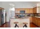 Well-lit kitchen with hardwood floors, stainless steel appliances, and a functional center island at 7496 Chipmunk Pl, Littleton, CO 80125