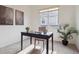 Well-lit home office featuring neutral carpets, a desk, a chair, and decor at 7496 Chipmunk Pl, Littleton, CO 80125