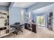 Large bedroom with built-in shelving, a piano, desk, and a sliding glass door providing access to a balcony at 7792 Garrison Ct, Arvada, CO 80005