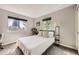 Bright bedroom features carpet, two windows letting in lots of natural light, and is furnished with a queen size bed and plants at 7792 Garrison Ct, Arvada, CO 80005