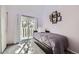 Bedroom featuring a neutral carpet, modern bed, closet, and sliding glass door providing access to a private balcony at 7792 Garrison Ct, Arvada, CO 80005