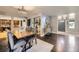 Dining area leading into the living room showcasing an open-concept design and hardwood floors at 7792 Garrison Ct, Arvada, CO 80005