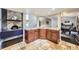 Kitchen countertop and breakfast bar area with granite countertops, decorative tile floor, and adjacent Gathering room and staircase at 7792 Garrison Ct, Arvada, CO 80005