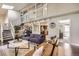 Spacious living room with vaulted ceiling, staircase, and open access to the kitchen and dining area at 7792 Garrison Ct, Arvada, CO 80005