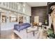 Open-concept living room featuring a vaulted ceiling, wood accent wall, and view into the kitchen at 7792 Garrison Ct, Arvada, CO 80005