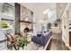 Bright living room showcasing a brick fireplace, skylight, and open staircase at 7792 Garrison Ct, Arvada, CO 80005