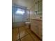 Bathroom featuring shower-tub combo and a single sink vanity with storage at 117 Valentine Ln, Longmont, CO 80501