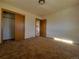 Cozy bedroom featuring a closet and view to another room, neutral carpeting at 117 Valentine Ln, Longmont, CO 80501