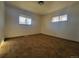 Bedroom with two windows offering great natural light and neutral carpet at 117 Valentine Ln, Longmont, CO 80501