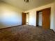 Spacious bedroom features neutral walls, carpet, and ample closet space at 117 Valentine Ln, Longmont, CO 80501