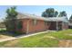 Charming single-story brick home with a well-manicured lawn and inviting walkway at 117 Valentine Ln, Longmont, CO 80501