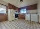 Well-lit kitchen featuring wood cabinets, appliances and convenient washer/dryer at 117 Valentine Ln, Longmont, CO 80501
