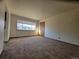 Bright living room with ample natural light, neutral walls and carpeting at 117 Valentine Ln, Longmont, CO 80501