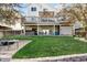 A backyard featuring a two-story deck, lush lawn, and a cozy fire pit area for outdoor enjoyment at 17067 Motsenbocker Way, Parker, CO 80134