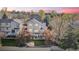 Aerial view of a home with a spacious backyard, lush lawn, and mature trees in a residential neighborhood at 17067 Motsenbocker Way, Parker, CO 80134