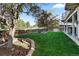 Well-maintained backyard with a lush lawn, mature trees, and a fire pit, ideal for outdoor gatherings and relaxation at 17067 Motsenbocker Way, Parker, CO 80134
