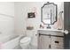 Well decorated bathroom with bathtub, light grey vanity with wood accents, and white and pink decor at 17067 Motsenbocker Way, Parker, CO 80134