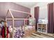 Adorable room featuring a house frame bed, a collection of plush toys, and playful decor with dark purple accent wall at 17067 Motsenbocker Way, Parker, CO 80134