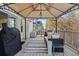 Outdoor deck featuring a grill, a canopy, and stylish furniture, creating a comfortable and functional space at 17067 Motsenbocker Way, Parker, CO 80134