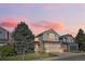 Two-story home with a well-maintained front yard and garage, set against a colorful sky at 17067 Motsenbocker Way, Parker, CO 80134