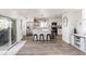 Bright, modern kitchen featuring white cabinets, stainless steel appliances, and an island with bar seating at 17067 Motsenbocker Way, Parker, CO 80134