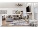 Cozy living room with a fireplace, a ceiling fan, and natural light at 17067 Motsenbocker Way, Parker, CO 80134