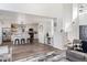 Bright open floor plan showcasing the kitchen with modern appliances, bar seating, and seamless flow into the living area at 17067 Motsenbocker Way, Parker, CO 80134
