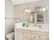 Well-lit double vanity bathroom featuring a mirror reflecting a bedroom with a shower at 6657 Drew Ranch Ln, Boulder, CO 80301