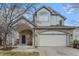 Charming two-story home featuring a stone facade, covered entrance, and attached two-car garage at 6657 Drew Ranch Ln, Boulder, CO 80301