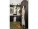 Stylish bathroom featuring unique tile floor, dark cabinets, and a charming robe on the dark wooden door at 3 Carriage Brook Rd, Cherry Hills Village, CO 80121